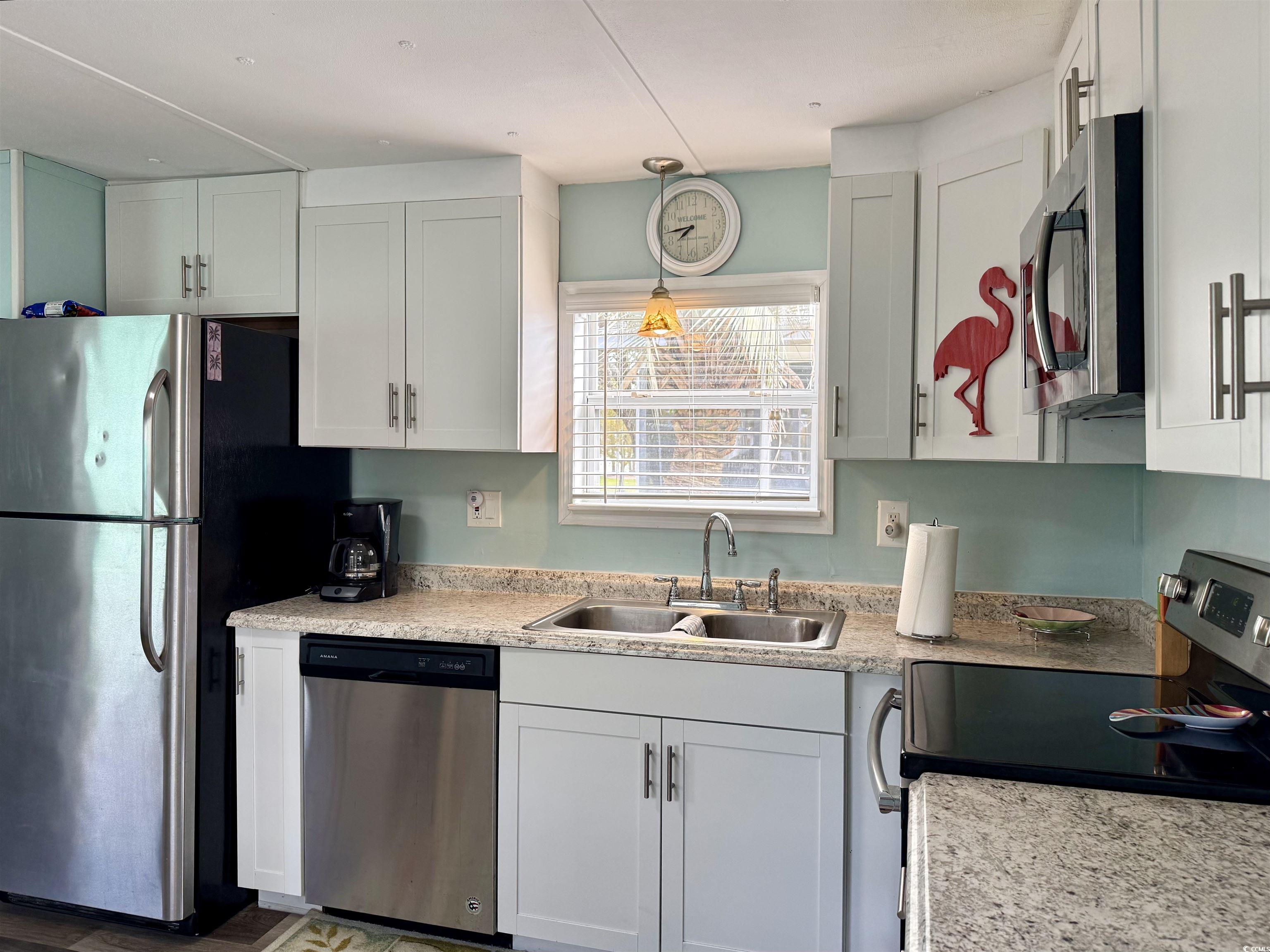 272 Flamingo Surfside Beach, SC 29575 - Photo 13 of 39 Kitchen featuring light countertops, a sink, white