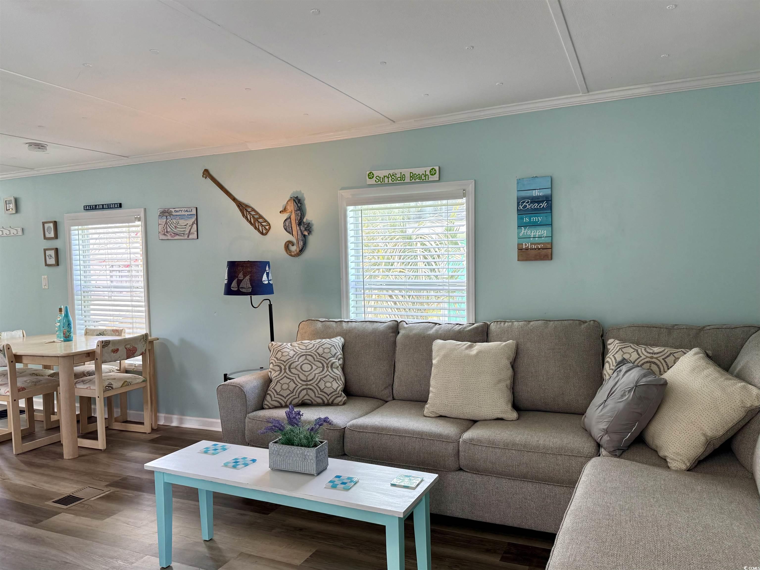272 Flamingo Surfside Beach, SC 29575 - Photo 23 of 39 Living room with dark wood-style flooring, crown m