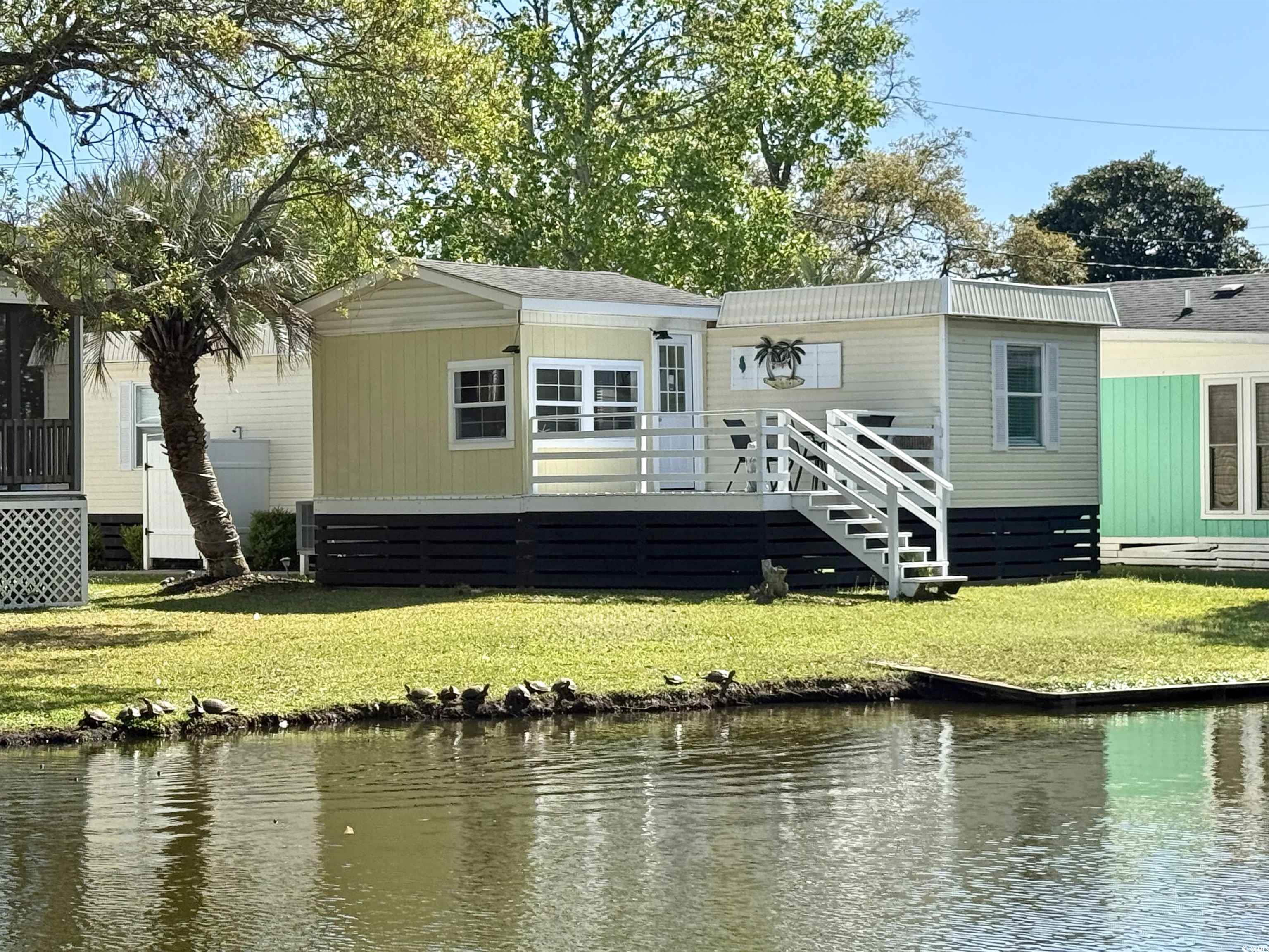 272 Flamingo Surfside Beach, SC 29575 - Photo 3 of 39 Back of property featuring a deck with water view,