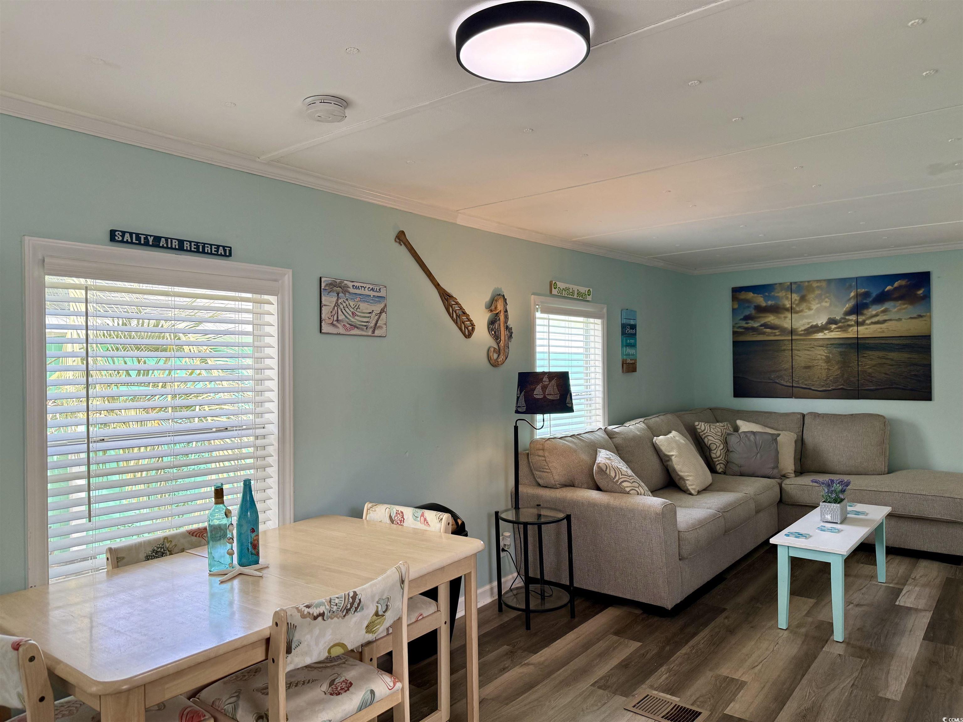 272 Flamingo Surfside Beach, SC 29575 - Photo 10 of 39 Living area with wood finished floors and crown mo