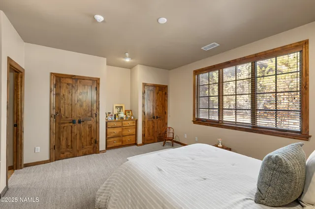 a bedroom with a bed and a large window