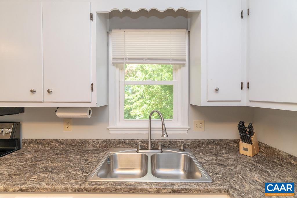 6920 Albevanna Spring Road Scottsville, VA 24590 - Photo 13 of 47 a kitchen with granite countertop a sink a window and cabinets