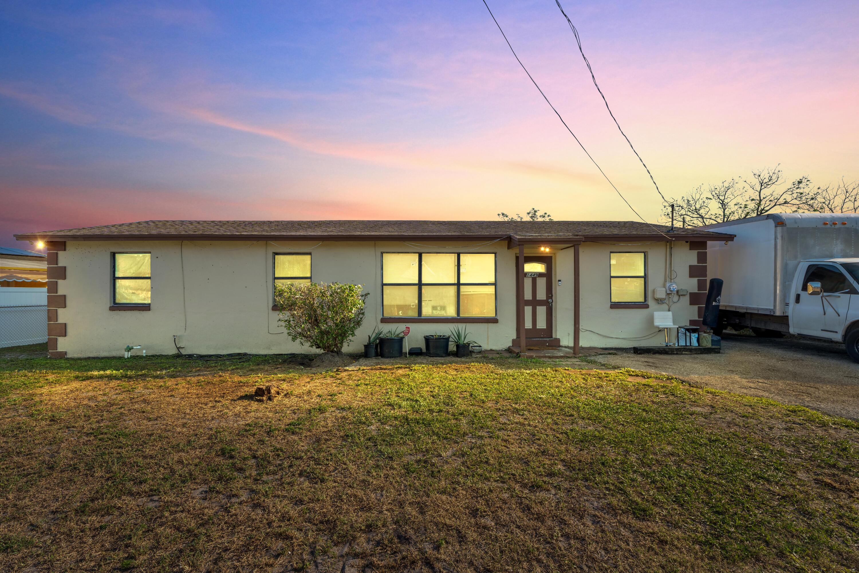 1449 West 35th Street Riviera Beach, FL 33404 - Photo 1 of 28 a view of a house with backyard and porch