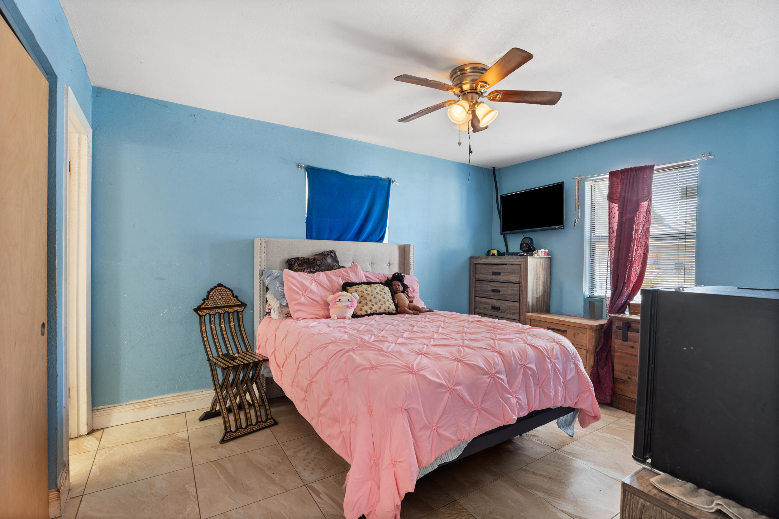 1449 West 35th Street Riviera Beach, FL 33404 - Photo 11 of 28 a bedroom with a bed and a ceiling fan