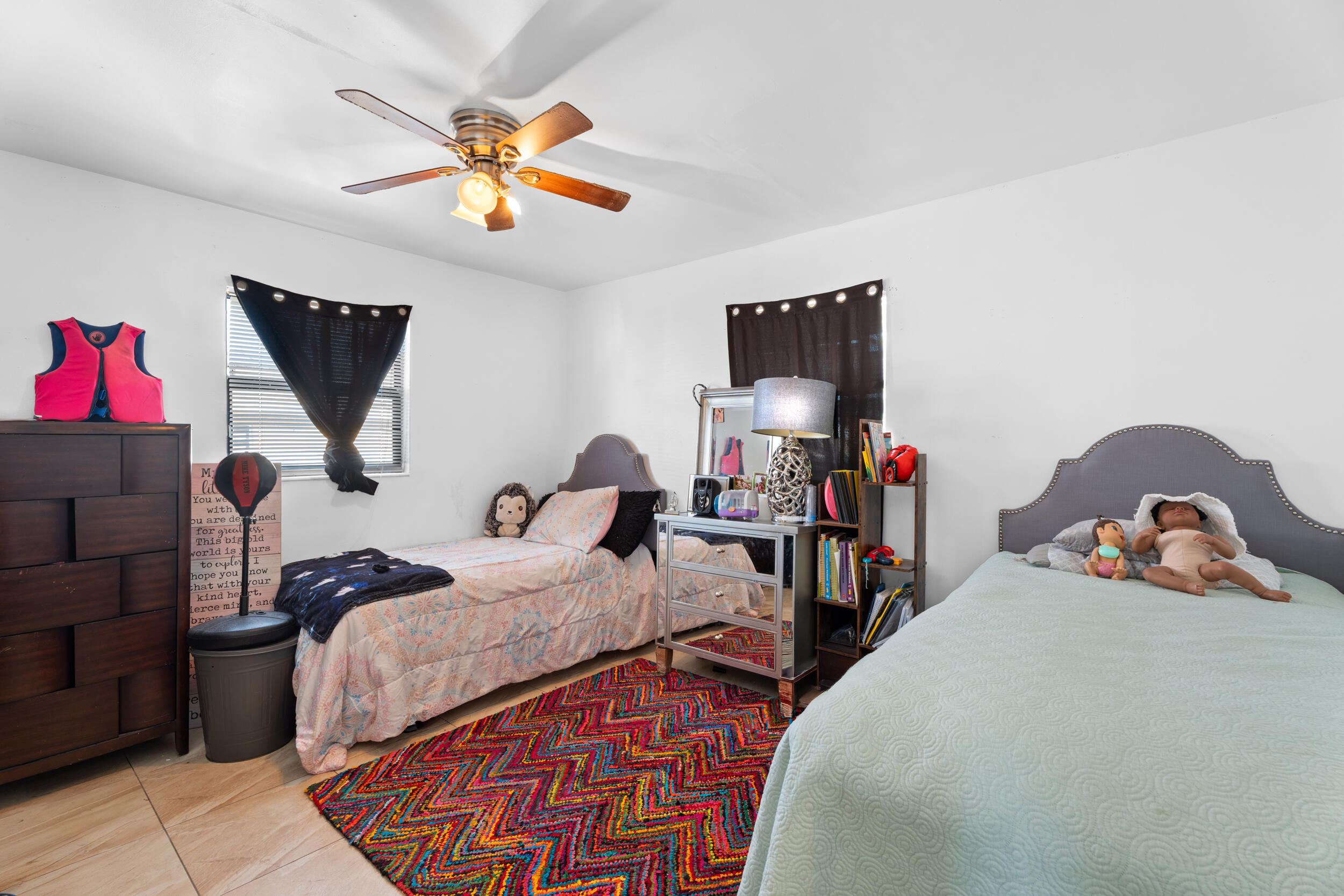 1449 West 35th Street Riviera Beach, FL 33404 - Photo 15 of 28 a bedroom with bed and a chandelier