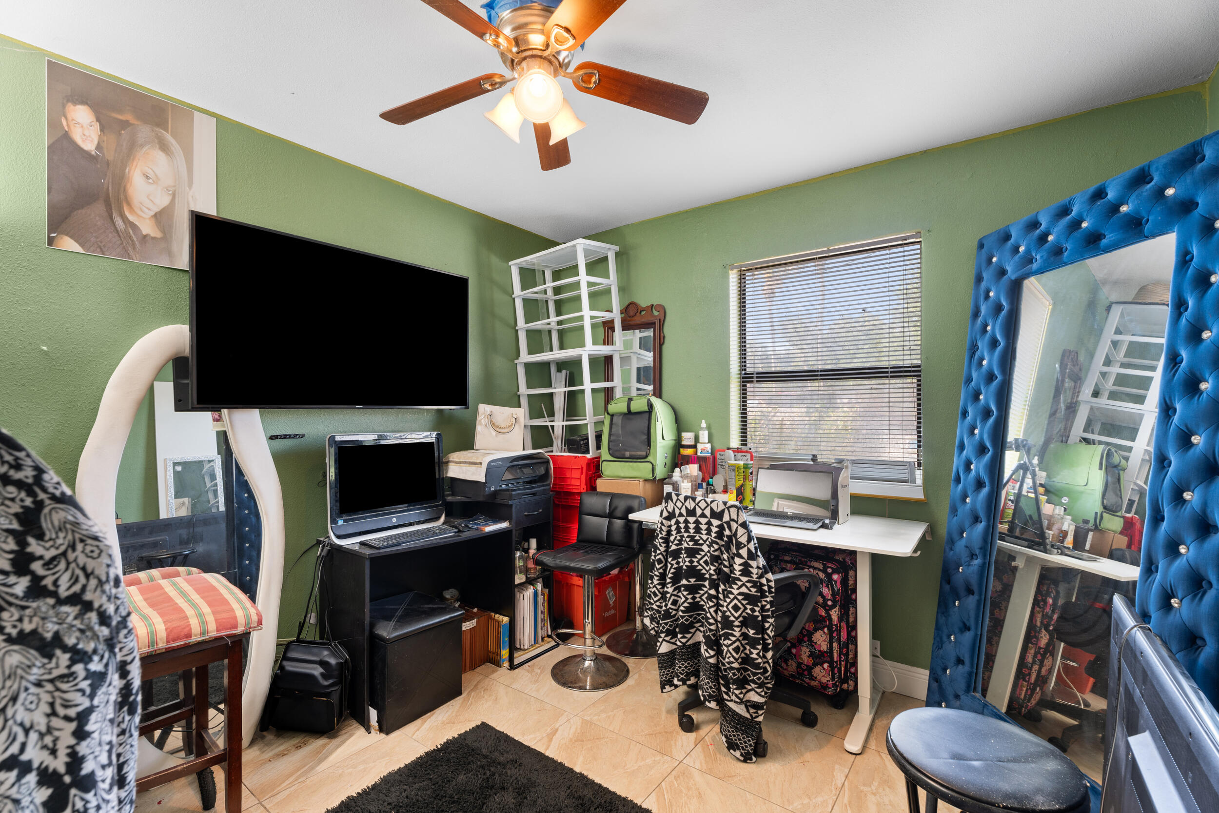 1449 West 35th Street Riviera Beach, FL 33404 - Photo 17 of 28 a view of a workspace with furniture and a flat screen tv