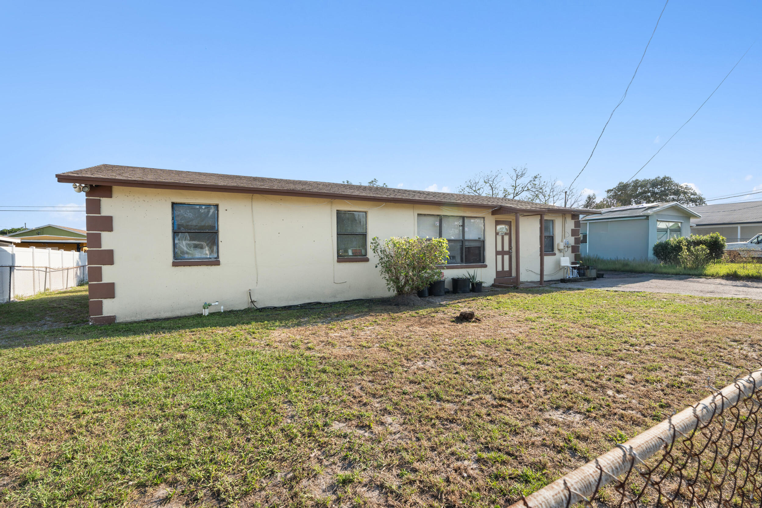 1449 West 35th Street Riviera Beach, FL 33404 - Photo 2 of 28 a house view with a garden space