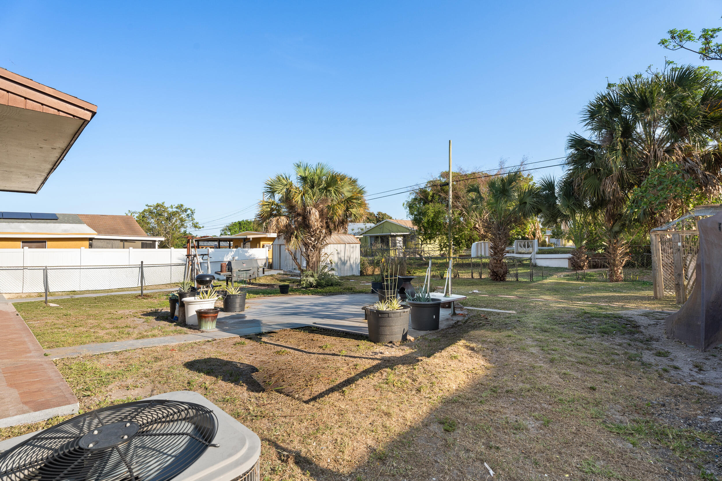 1449 West 35th Street Riviera Beach, FL 33404 - Photo 21 of 28 a view of a yard with swimming pool
