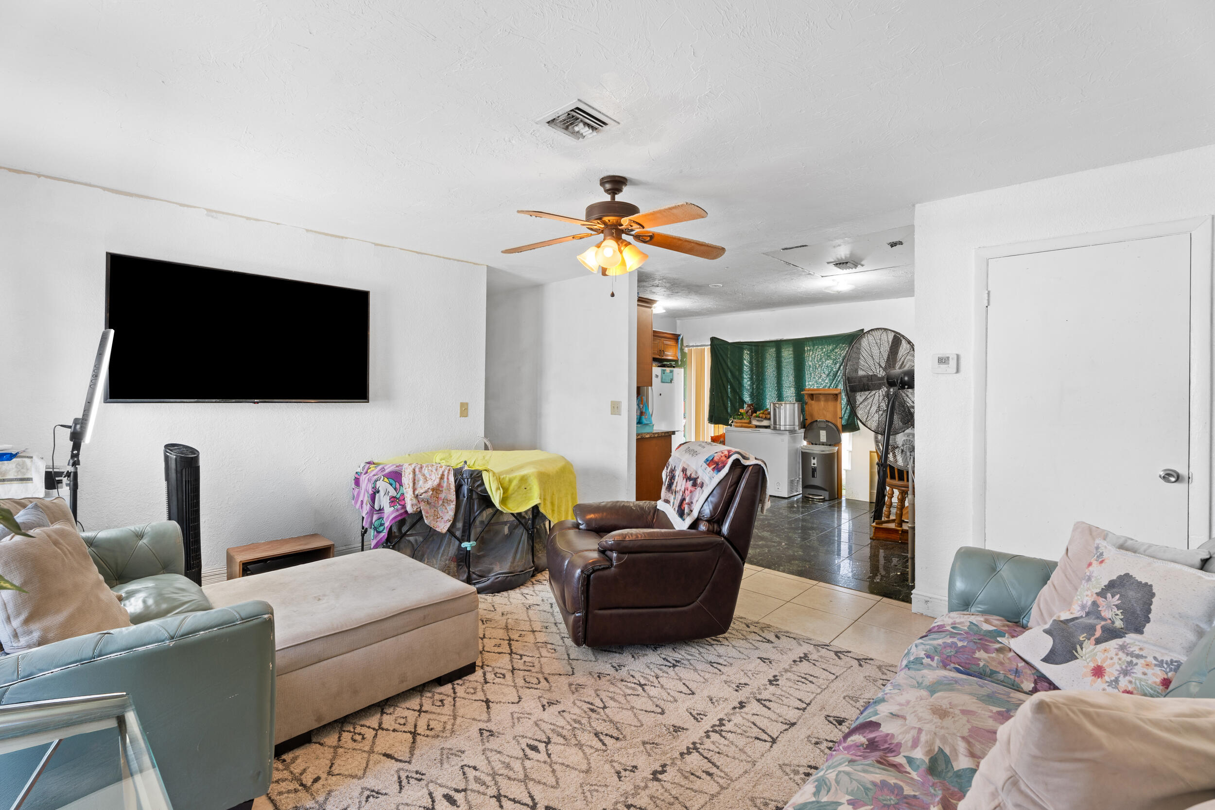 1449 West 35th Street Riviera Beach, FL 33404 - Photo 4 of 28 a living room with furniture and a flat screen tv