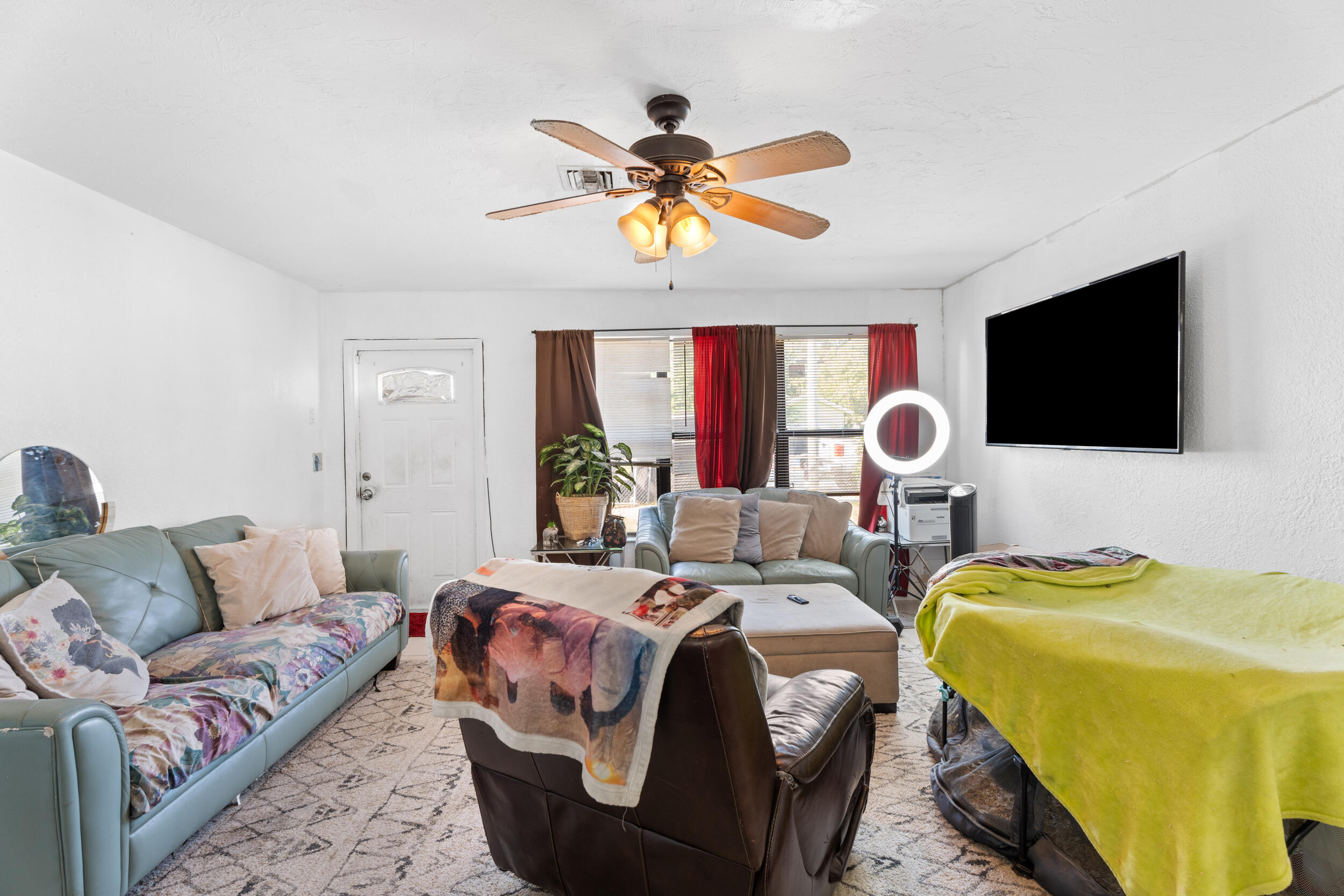 1449 West 35th Street Riviera Beach, FL 33404 - Photo 5 of 28 a bedroom with a bed and a flat screen tv