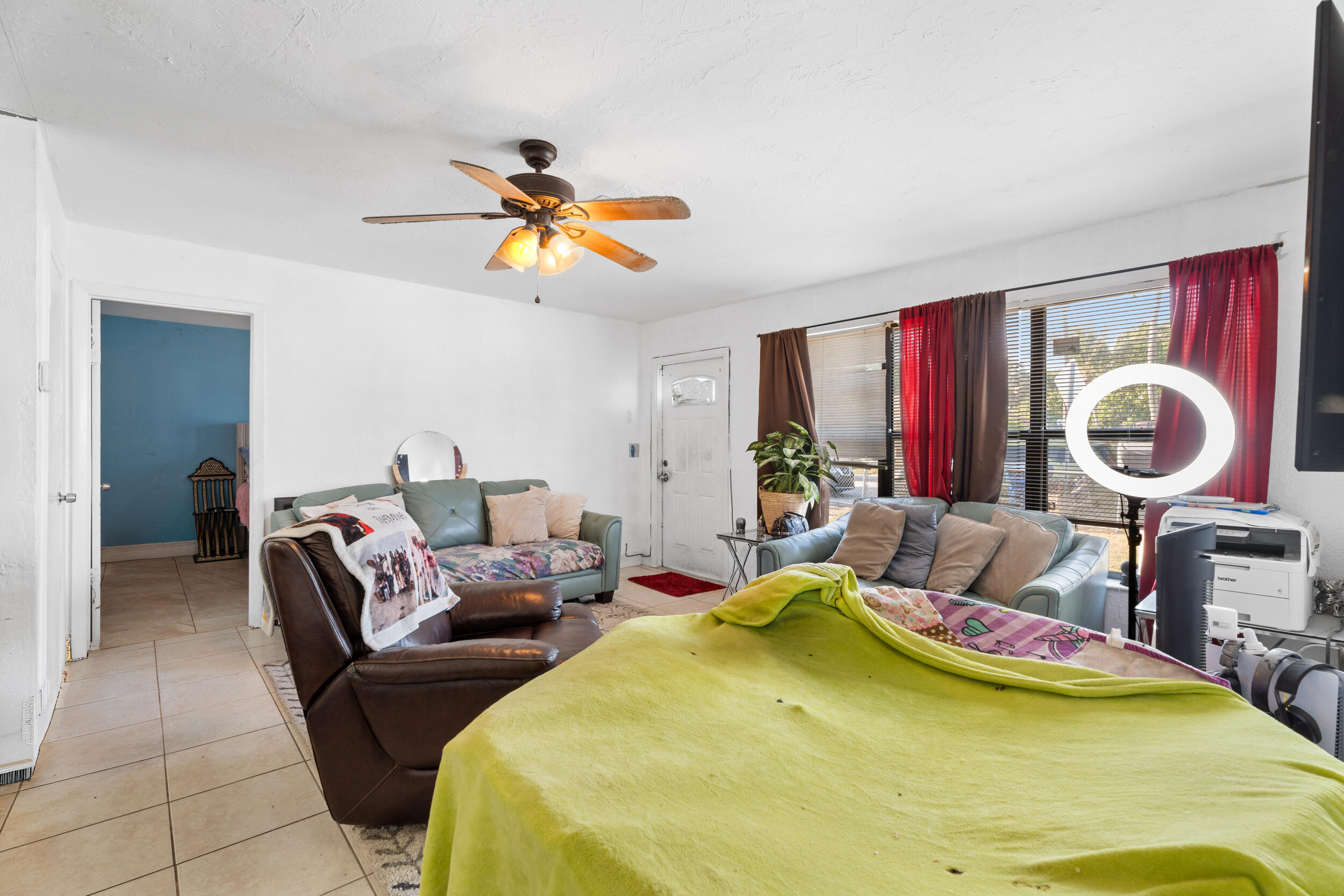 1449 West 35th Street Riviera Beach, FL 33404 - Photo 6 of 28 a living room with furniture and a chandelier