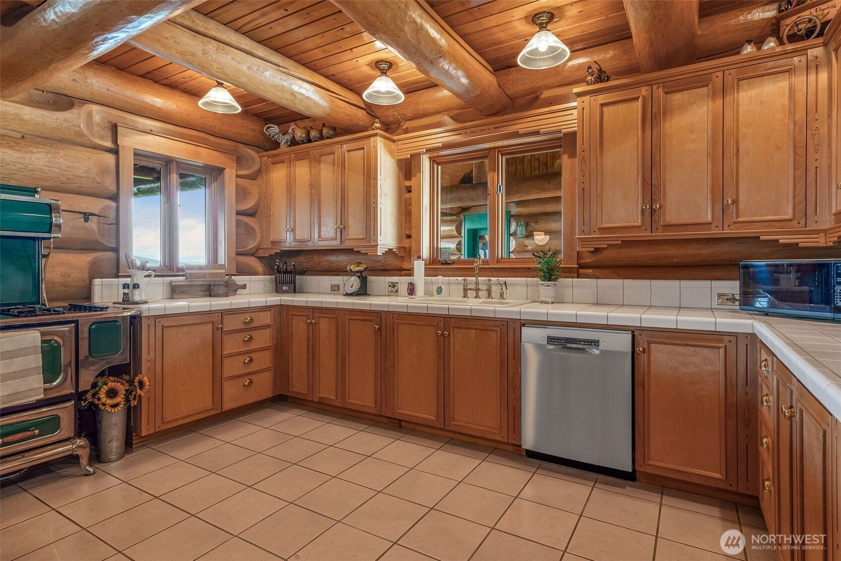 53 Combs Place Port Townsend, WA 98368 - Photo 16 of 40 a kitchen with a sink window and cabinets
