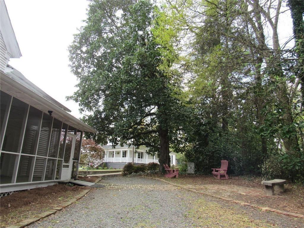 300 Church Street Rockmart, GA 30153 - Photo 12 of 63 a view of a barn with wooden fence and large trees