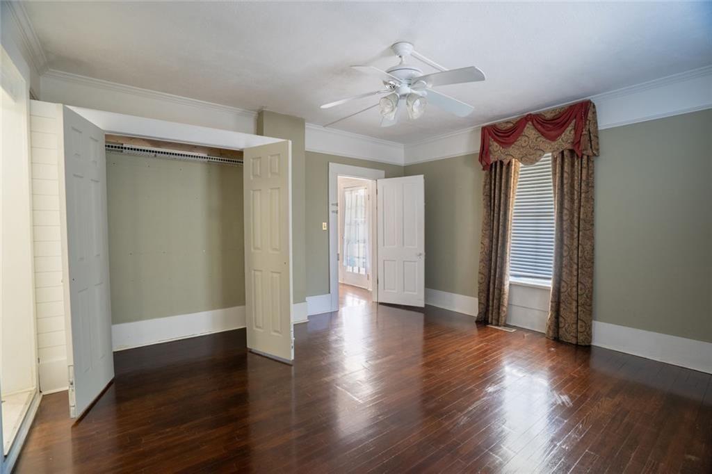 300 Church Street Rockmart, GA 30153 - Photo 24 of 63 an empty room with wooden floor closet and windows