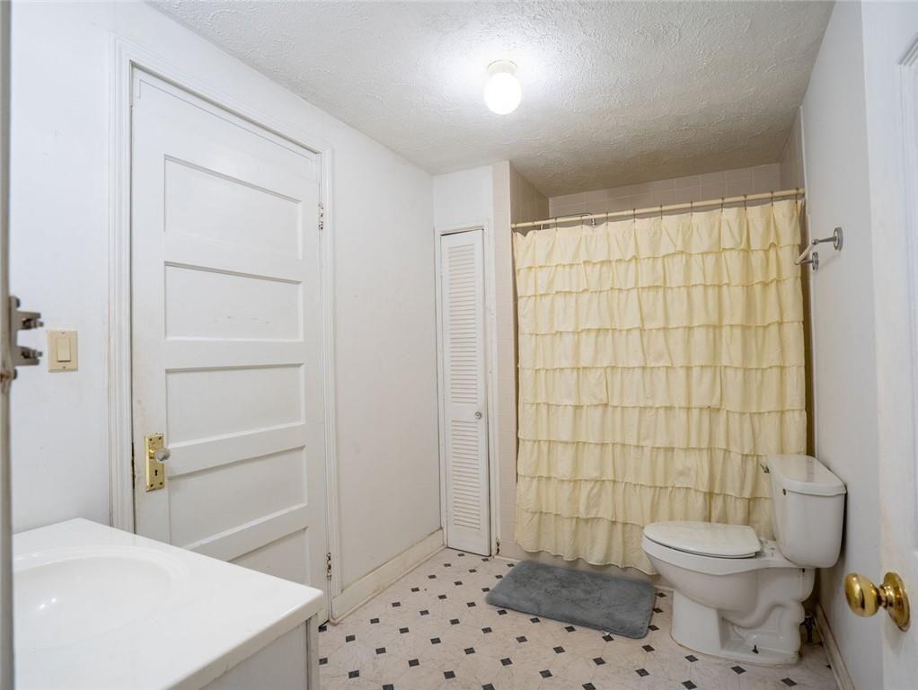 300 Church Street Rockmart, GA 30153 - Photo 27 of 63 a bathroom with a toilet a sink and shower
