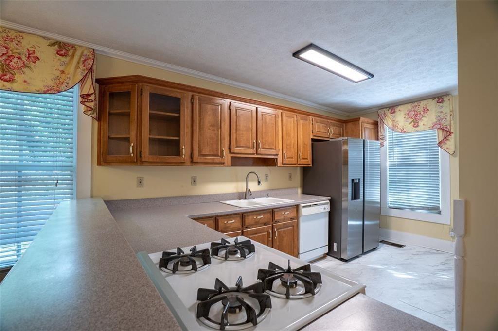 300 Church Street Rockmart, GA 30153 - Photo 31 of 63 a kitchen with stainless steel appliances a stove a sink and a refrigerator