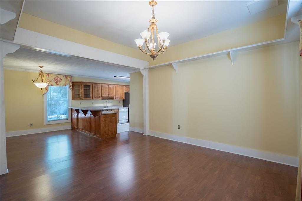 300 Church Street Rockmart, GA 30153 - Photo 35 of 63 wooden floor in an empty room with a kitchen