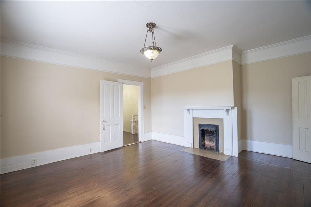 300 Church Street Rockmart, GA 30153 - Photo 38 of 63 an empty room with wooden floor fireplace and windows