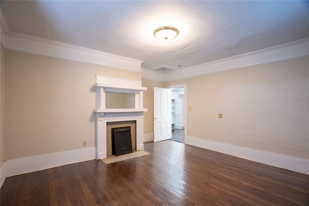 300 Church Street Rockmart, GA 30153 - Photo 40 of 63 a view of an empty room with a fireplace and a window