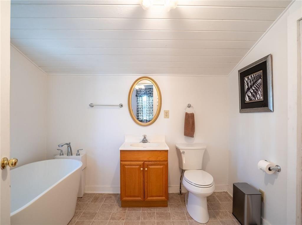 300 Church Street Rockmart, GA 30153 - Photo 43 of 63 a bathroom with a toilet a sink and a bathtub