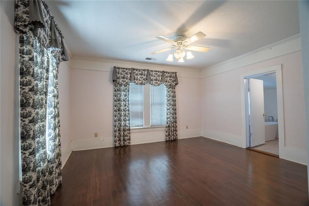 300 Church Street Rockmart, GA 30153 - Photo 45 of 63 an empty room with wooden floor chandelier fan and windows