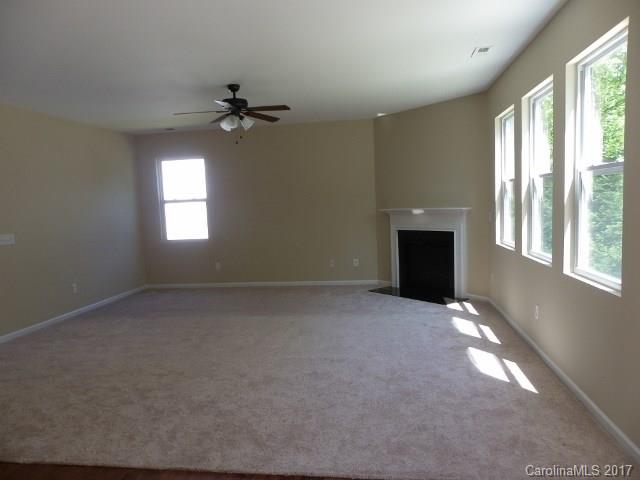 1124 Spicewood Pines Road Fort Mill, SC 29708 - Photo 3 of 16 an empty room with windows and fireplace