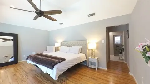 a bedroom with a bed and a large mirror