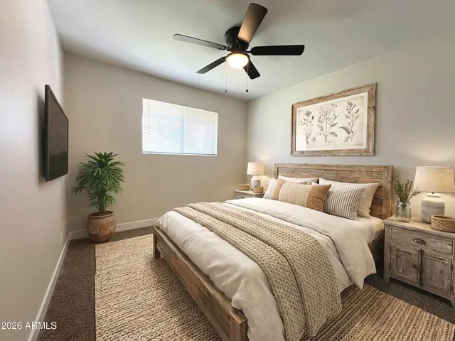 an empty room with windows and fan