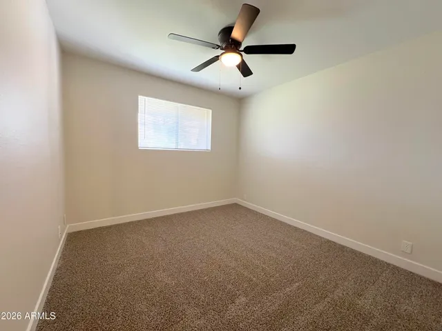 a bathroom with a granite countertop toilet a sink a bathtub and a mirror