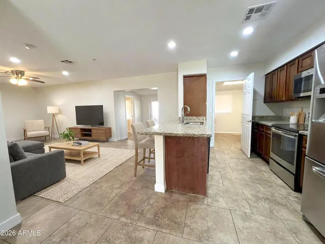 a bedroom with furniture and a ceiling fan