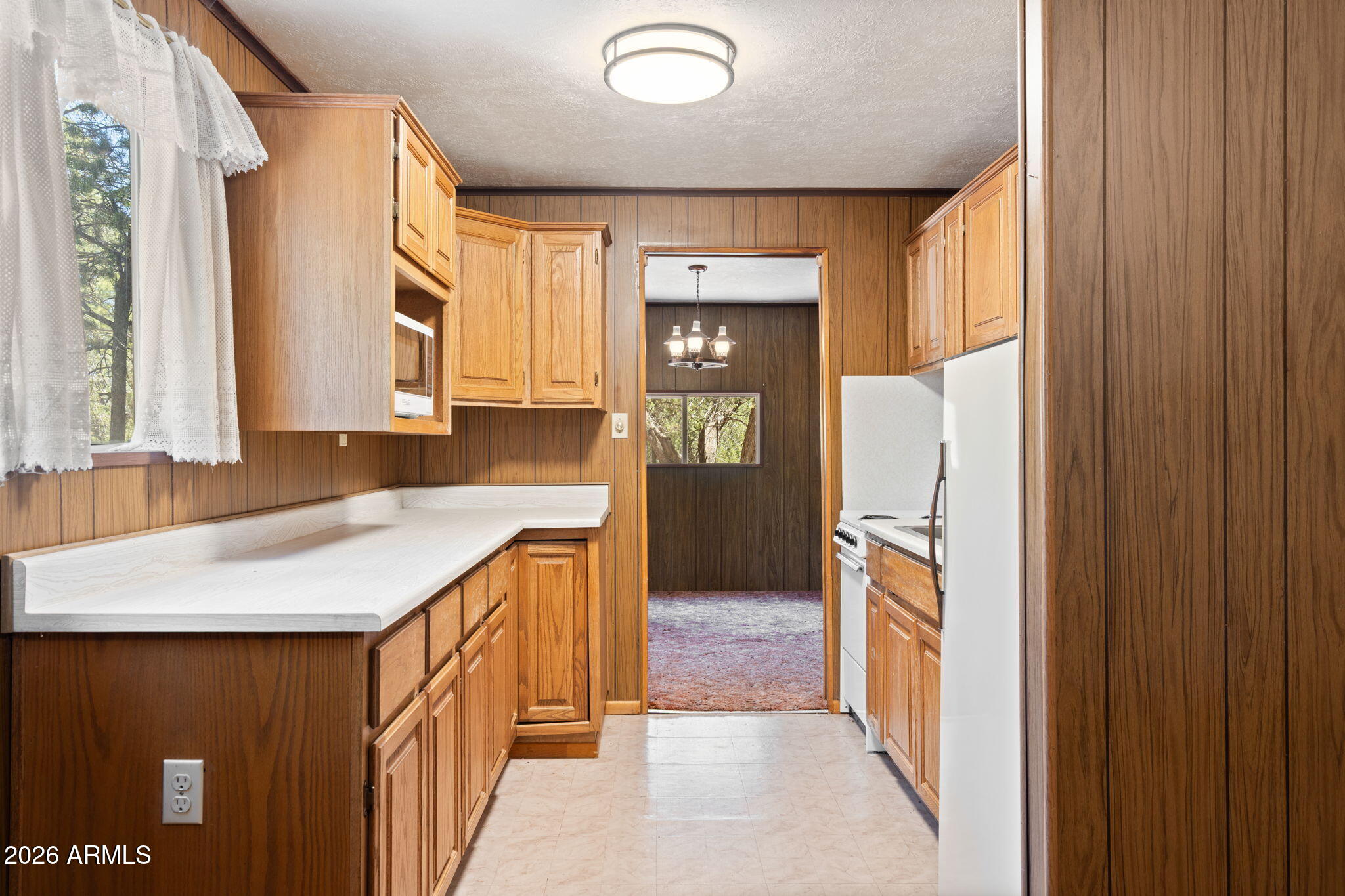 2943 Buckskin Road Overgaard, AZ 85933 - Photo 12 of 36 a kitchen with a sink a refrigerator and window