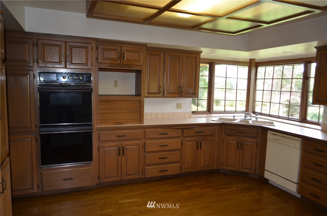 7878 Goodwin Road Everson, WA 98247 - Photo 3 of 16 a kitchen with a sink stove and refrigerator