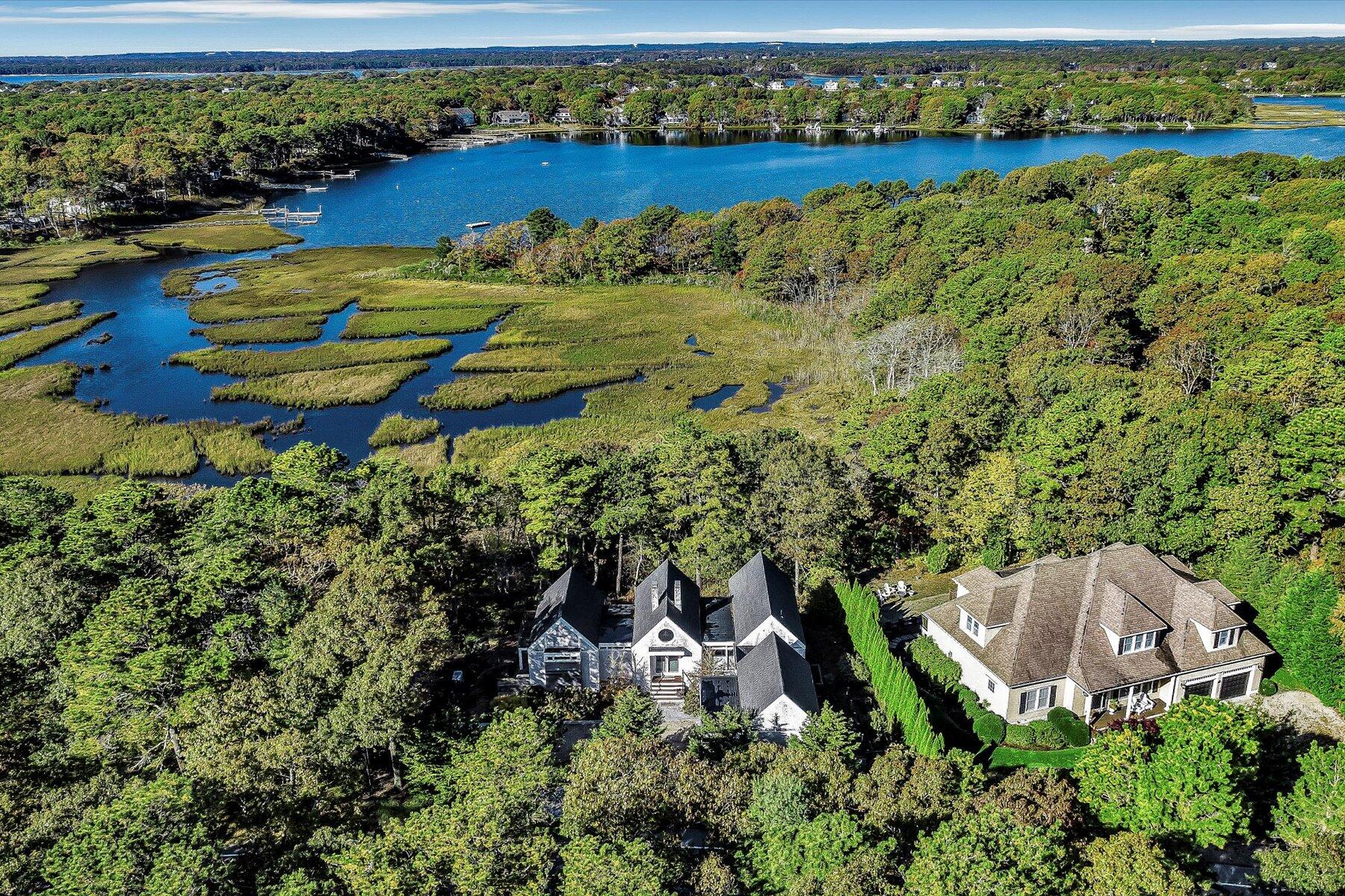 an aerial view of a house with a garden and lake view