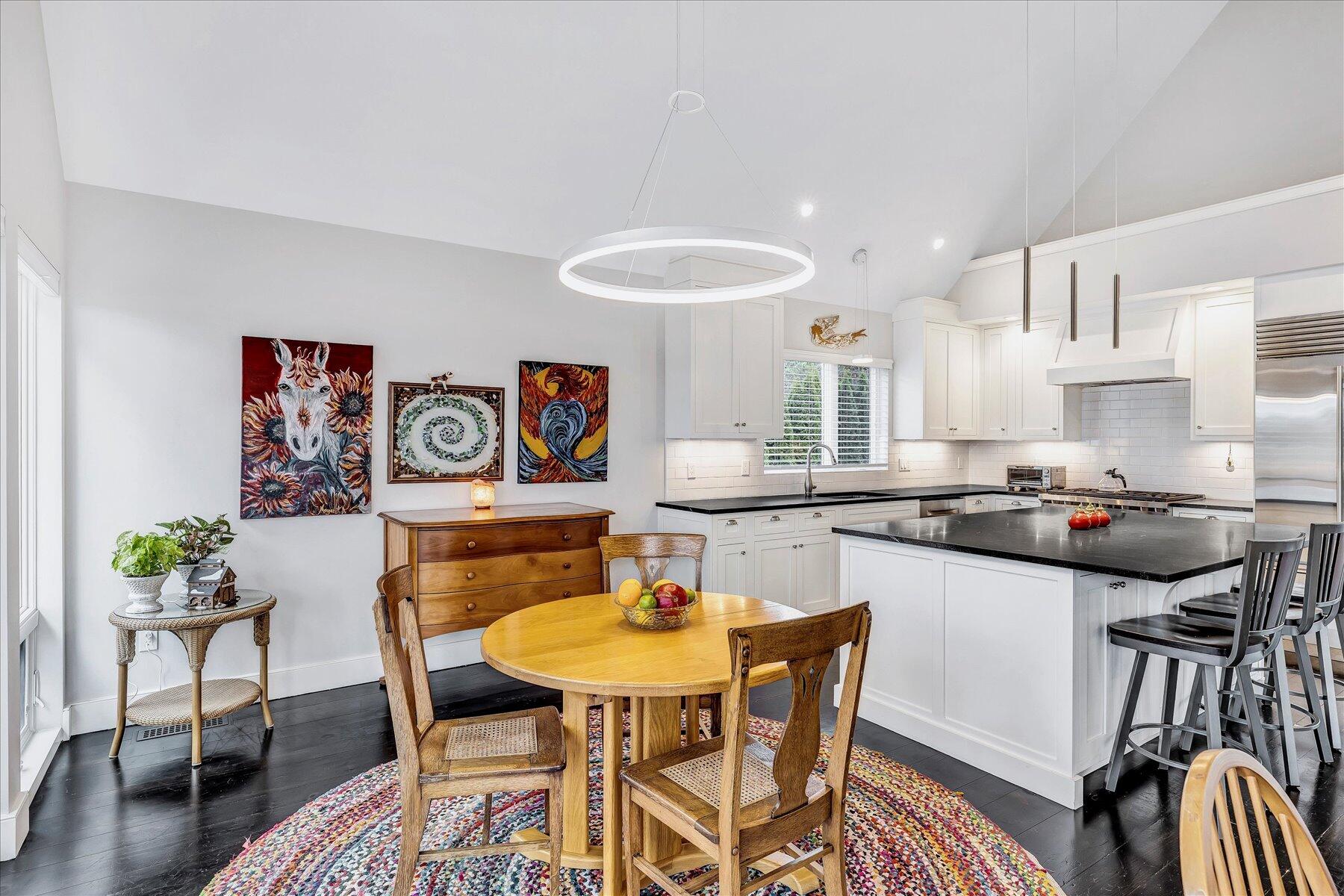 403 Great Oak Road Mashpee, MA 02649 - Photo 11 of 49 a kitchen with stainless steel appliances granite countertop a dining table chairs and a refrigerator
