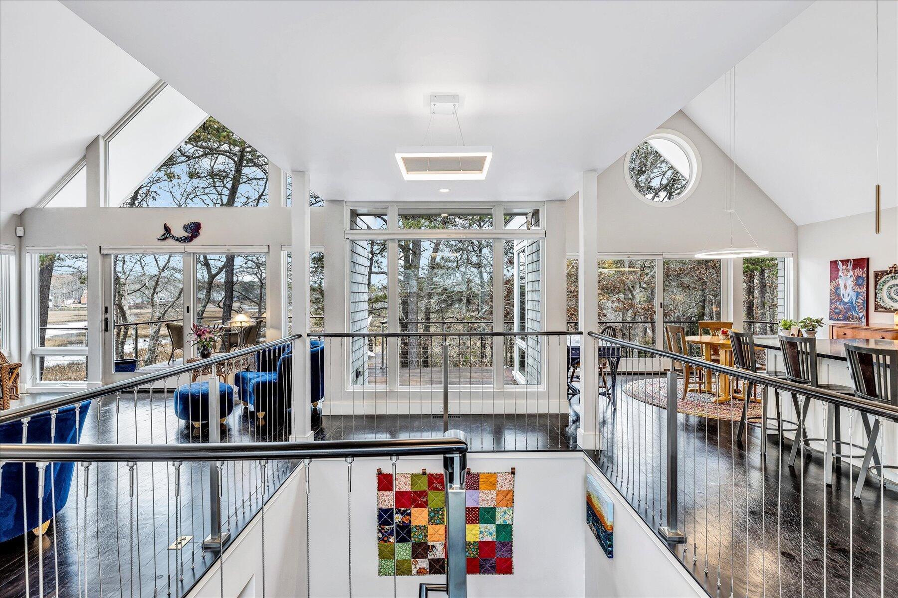 403 Great Oak Road Mashpee, MA 02649 - Photo 15 of 49 a view of a living room and a floor to ceiling window and wooden floor
