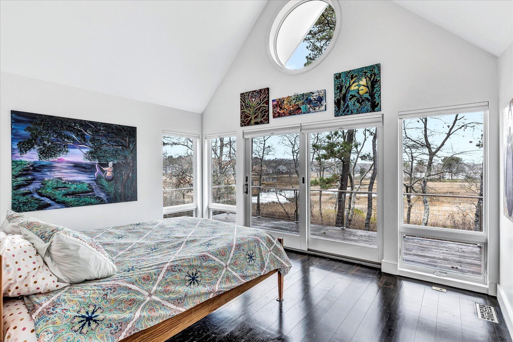 403 Great Oak Road Mashpee, MA 02649 - Photo 20 of 49 a bedroom with a balcony a bed and a large window