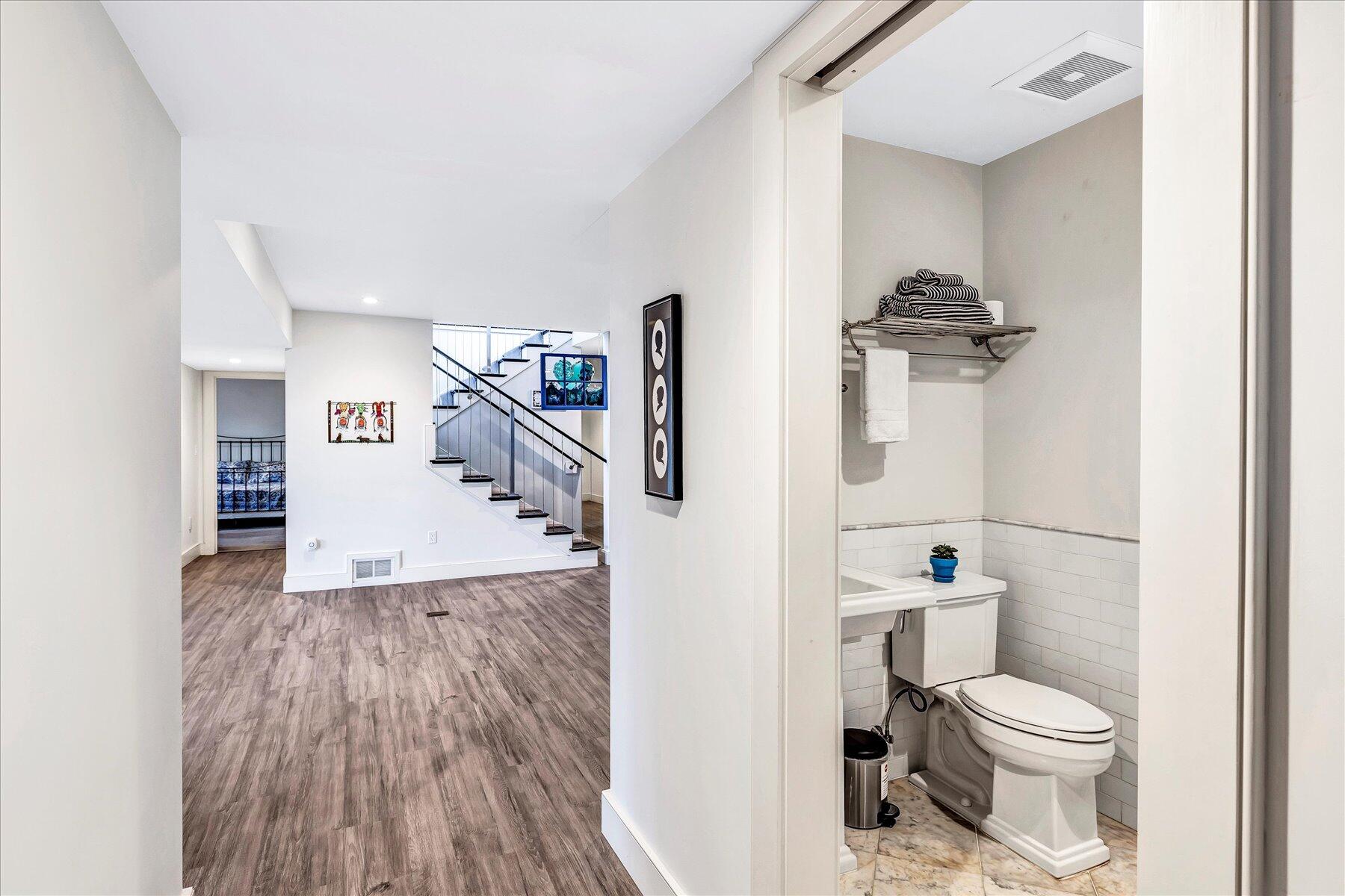 403 Great Oak Road Mashpee, MA 02649 - Photo 30 of 49 a bathroom with a toilet and a wooden floor