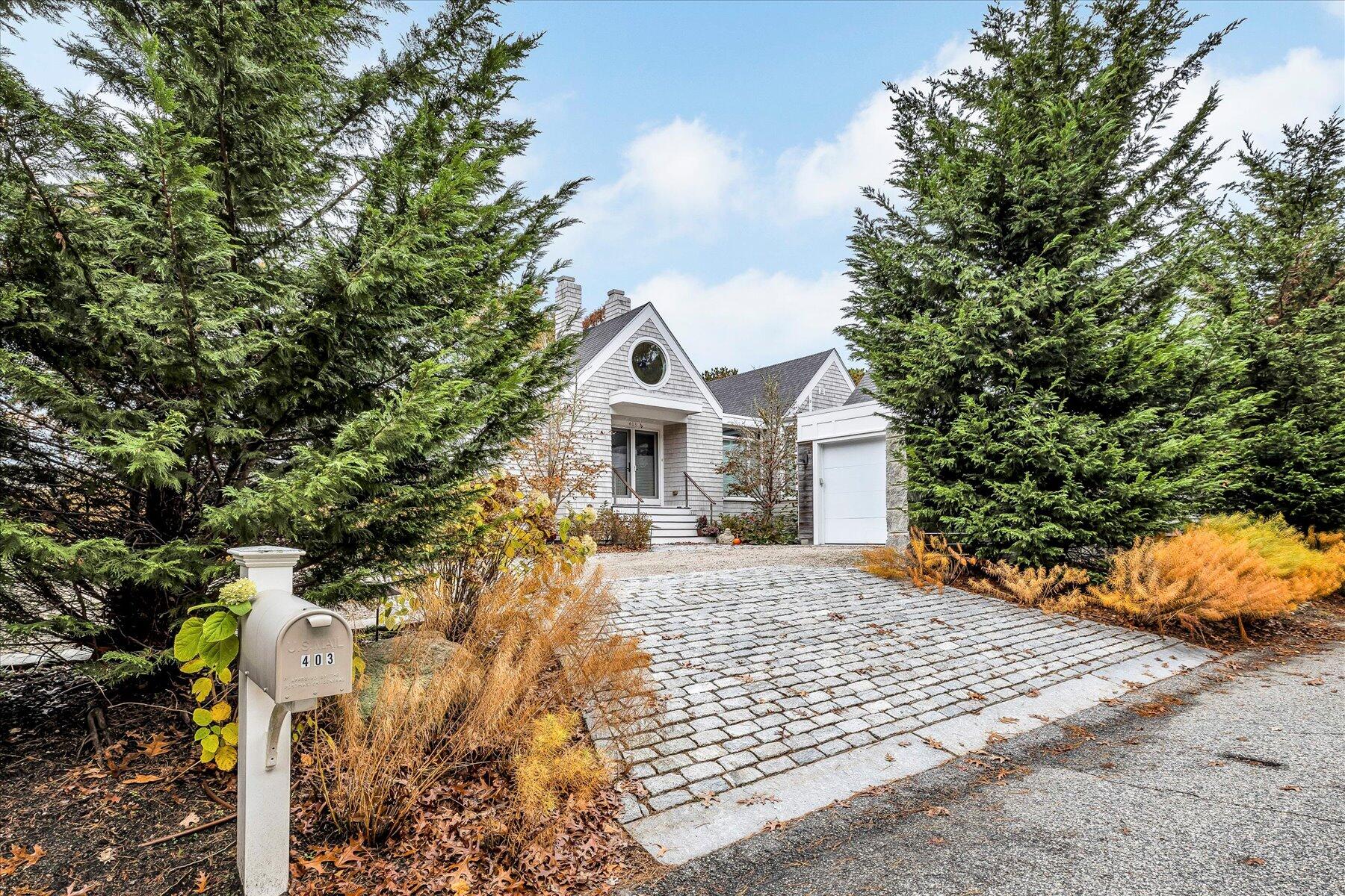 403 Great Oak Road Mashpee, MA 02649 - Photo 3 of 49 a front view of a house with a yard and garage