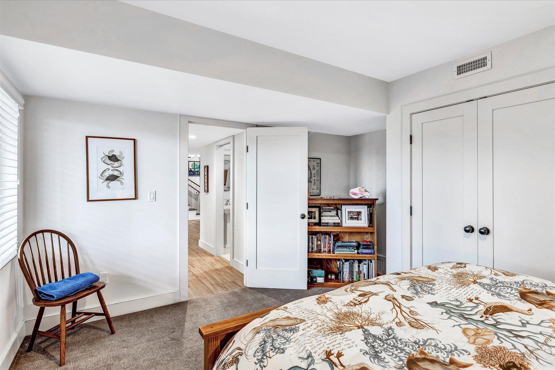 403 Great Oak Road Mashpee, MA 02649 - Photo 32 of 49 a bedroom with a bed and a chair