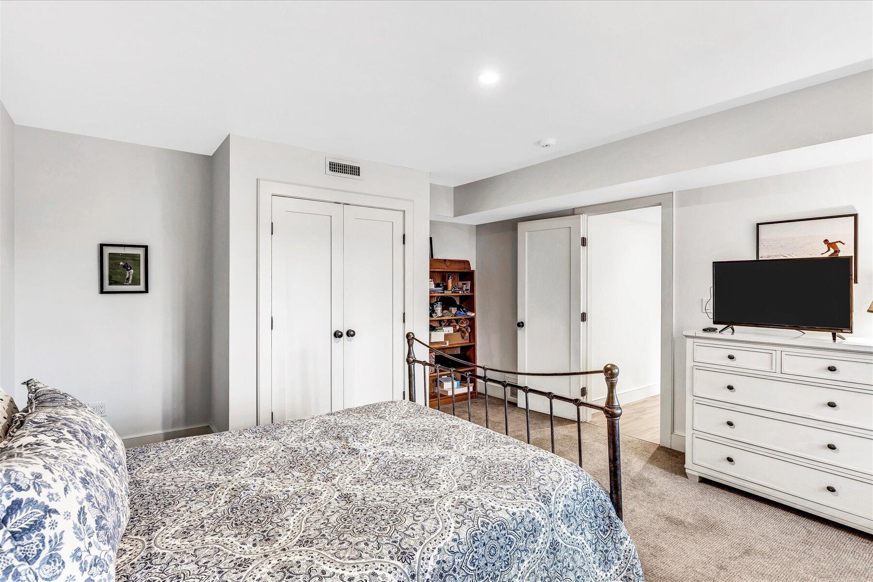 403 Great Oak Road Mashpee, MA 02649 - Photo 35 of 49 a bedroom with a bed and a television in it