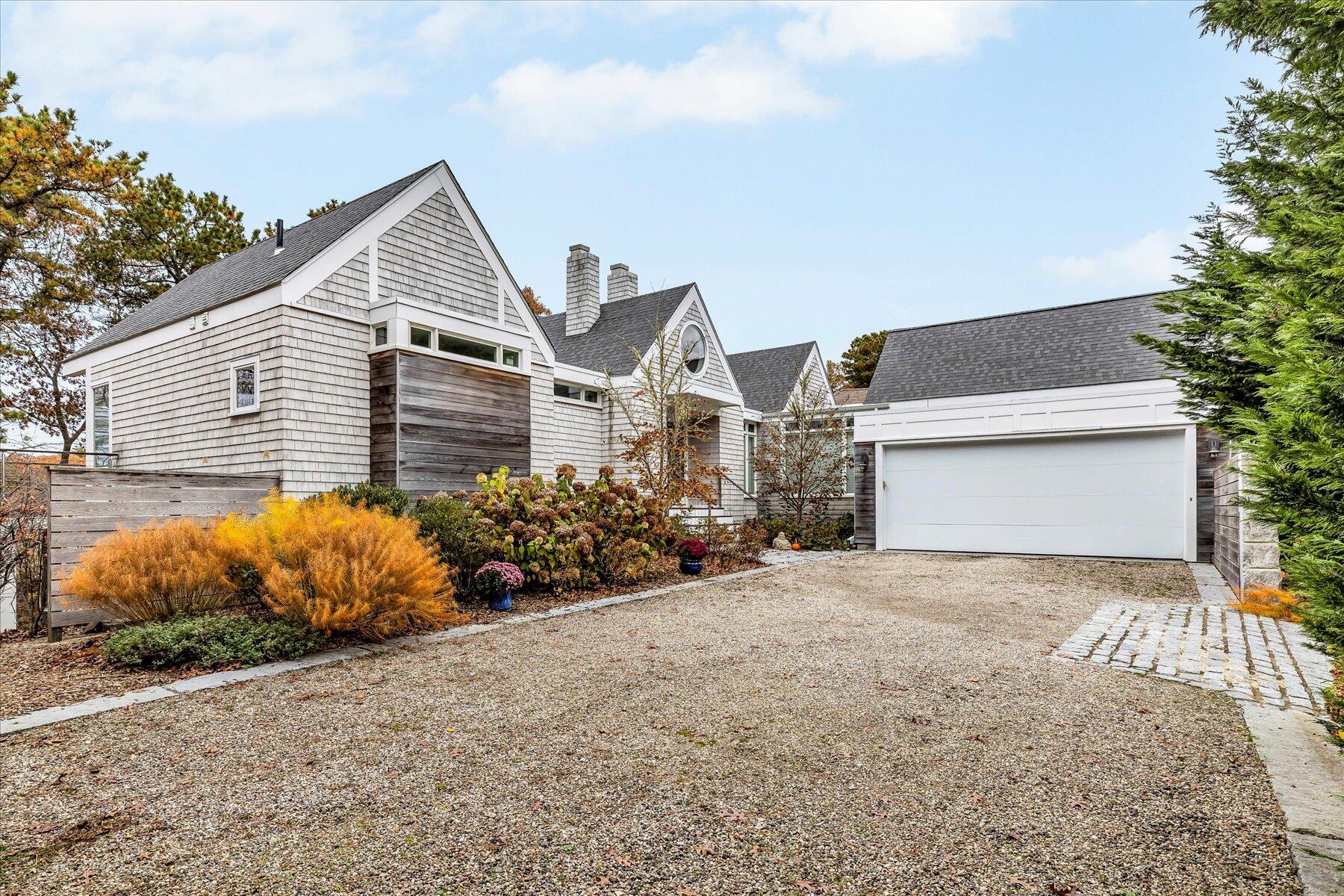 403 Great Oak Road Mashpee, MA 02649 - Photo 4 of 49 a front view of a house with a yard and garage