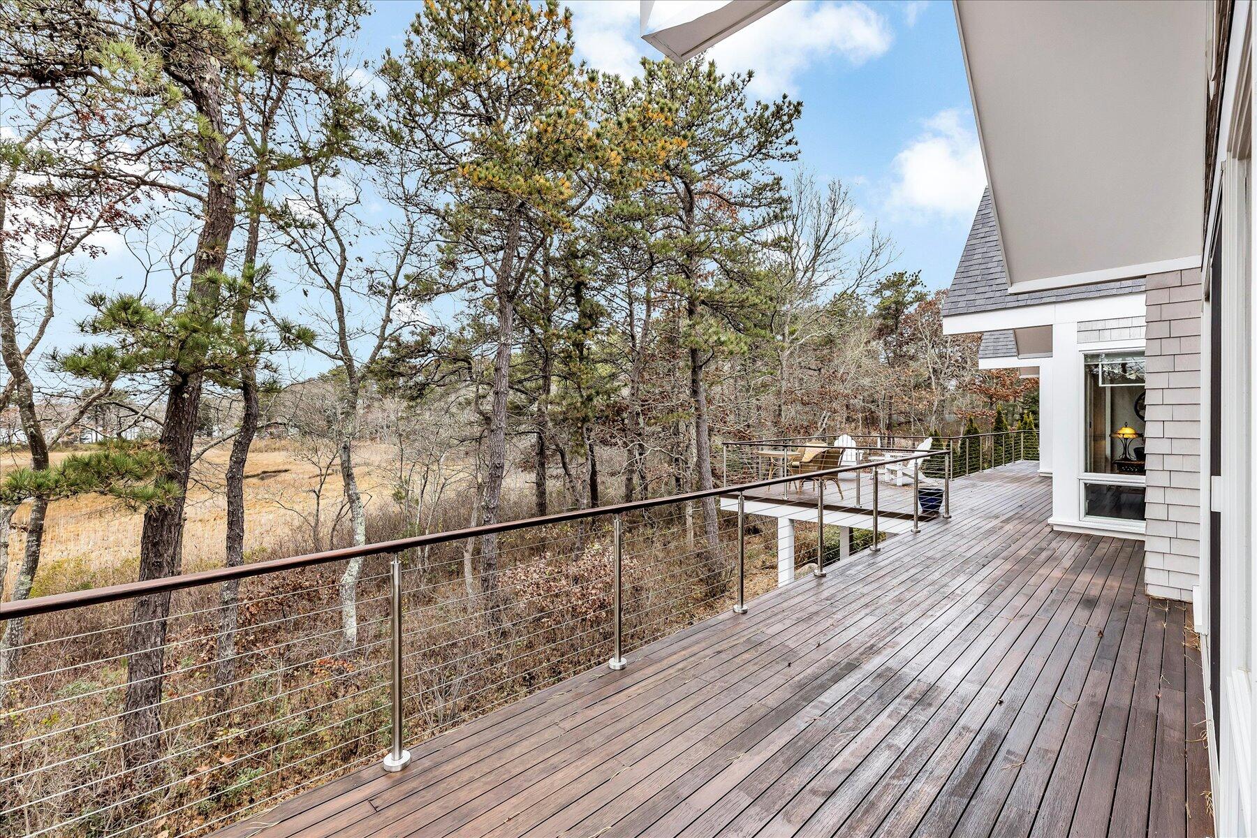 403 Great Oak Road Mashpee, MA 02649 - Photo 41 of 49 a view of a balcony with wooden floor and fence
