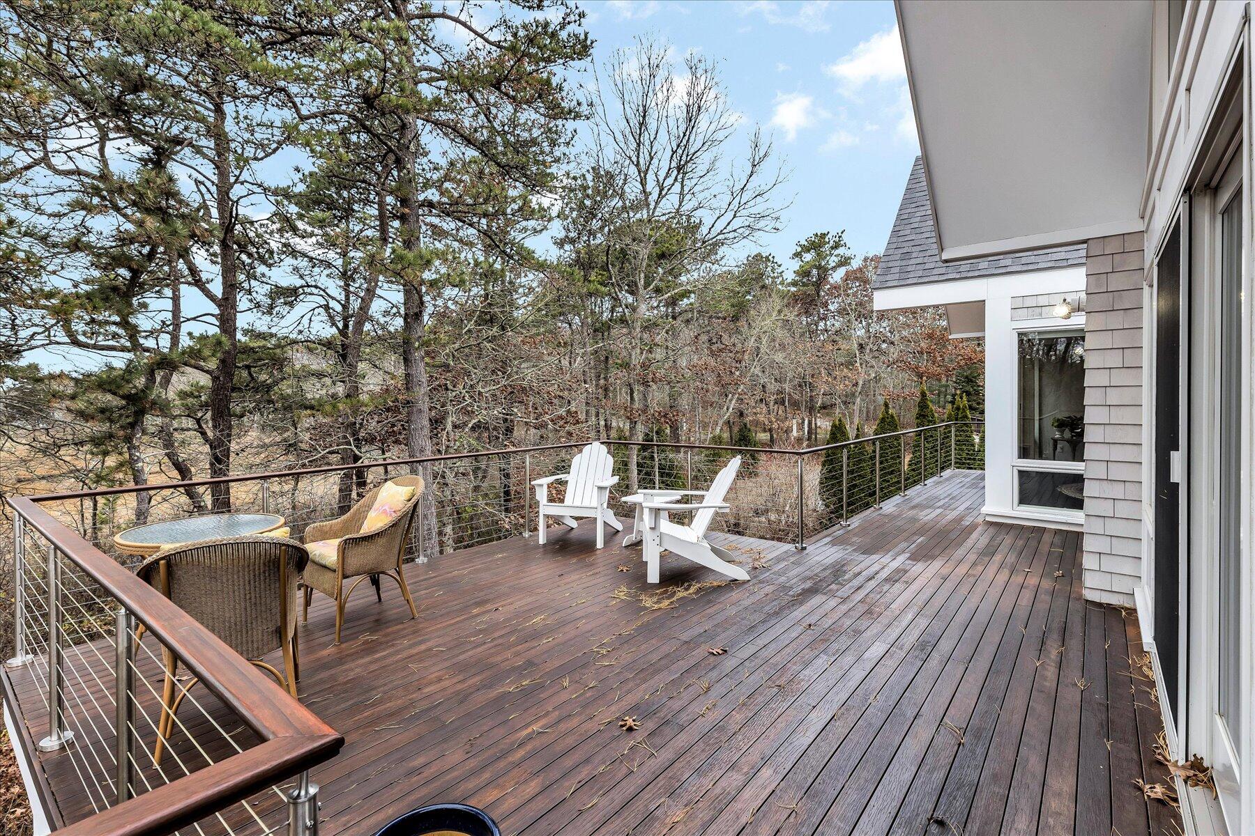 403 Great Oak Road Mashpee, MA 02649 - Photo 42 of 49 a view of a balcony with two chairs and wooden floor