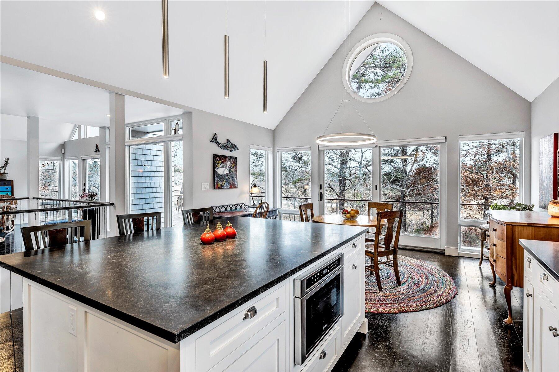 403 Great Oak Road Mashpee, MA 02649 - Photo 8 of 49 a kitchen with stainless steel appliances granite countertop a table chairs and a view of living room