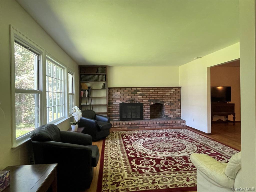 4 Cornwallis Road East Setauket, NY 11733 - Photo 2 of 16 a living room with furniture and a fireplace
