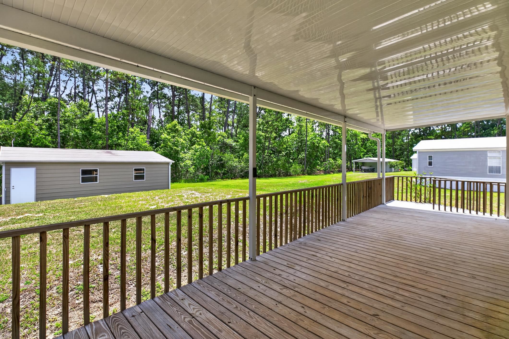 101 Trout Trail Crescent City, FL 32112 - Photo 22 of 45 a view of a deck with a yard