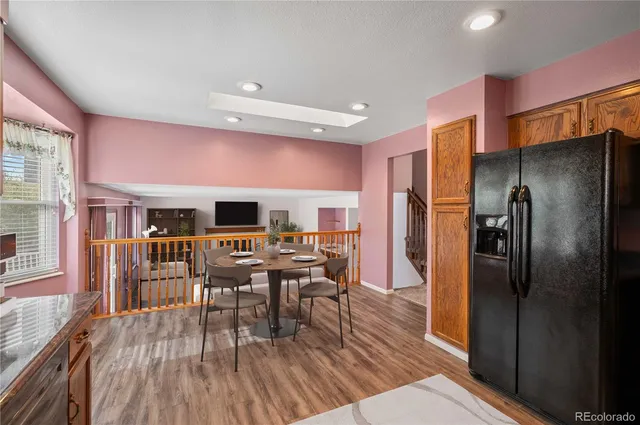 a living room with furniture a large window and a fireplace