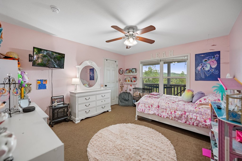 6 Gilliam Road Mineral Bluff, GA 30559 - Photo 18 of 42 a bedroom with a bed a chandelier and a dresser