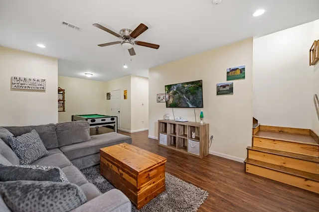 a living room with furniture and a wooden floor