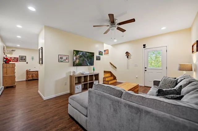 a living room with furniture and a wooden floor